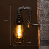 Black industrial iron pipe wall light with cage