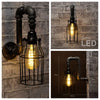 Black industrial iron pipe wall light with cage